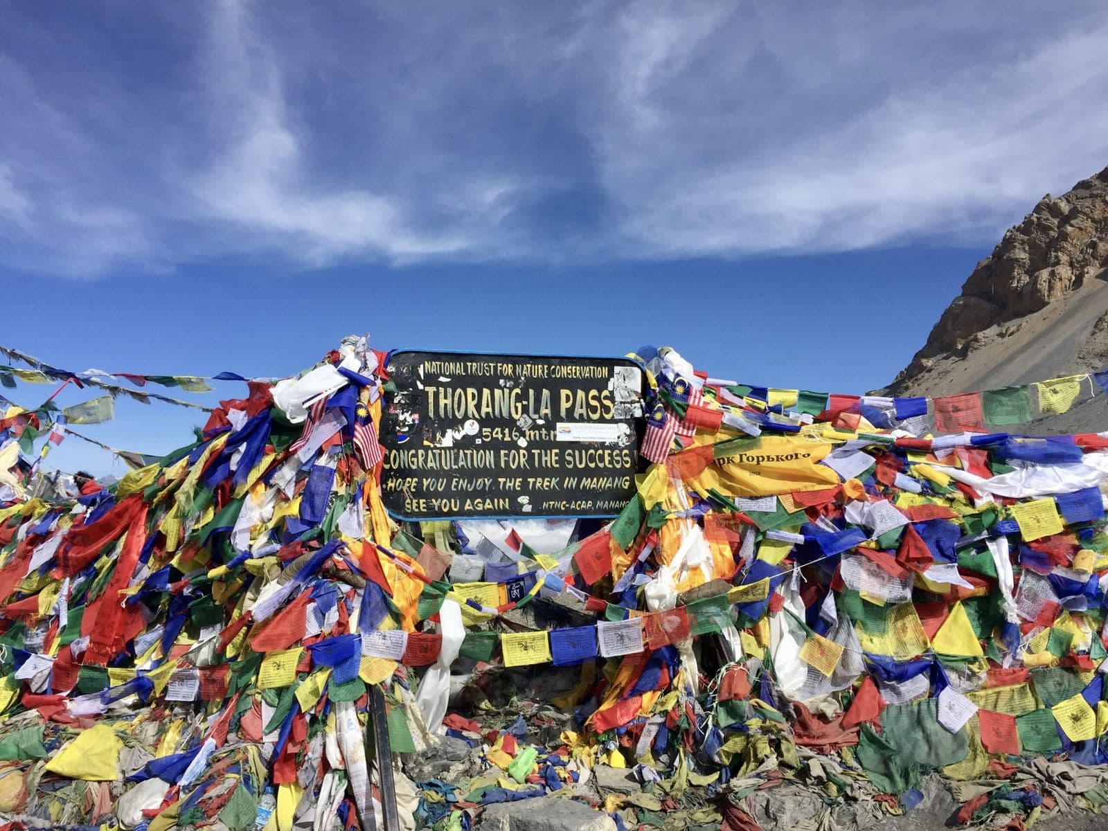 Prayer flags at the Thorong La Pass sign, 5,416 m