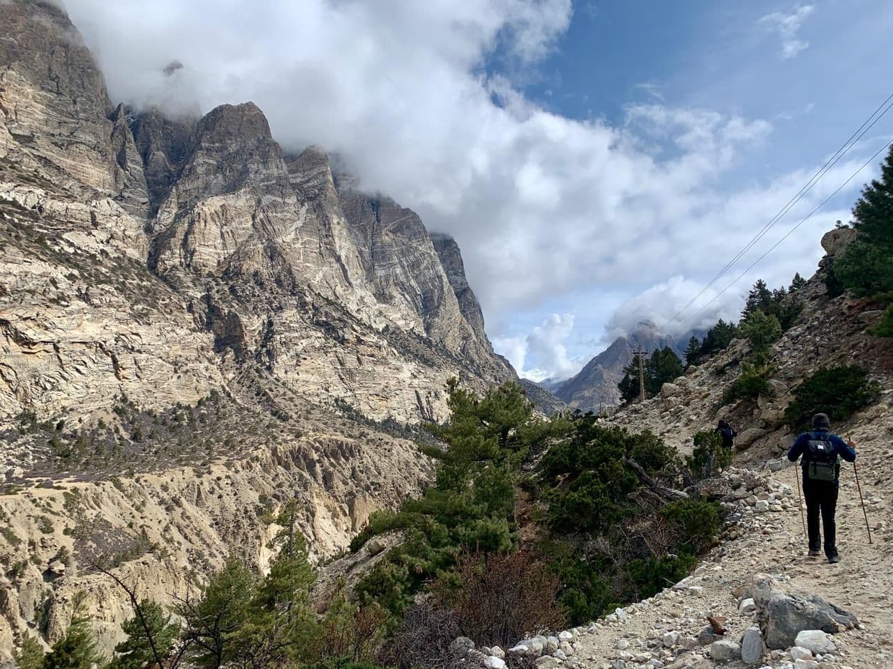 Trekker walking through a deep Himalayan gorge