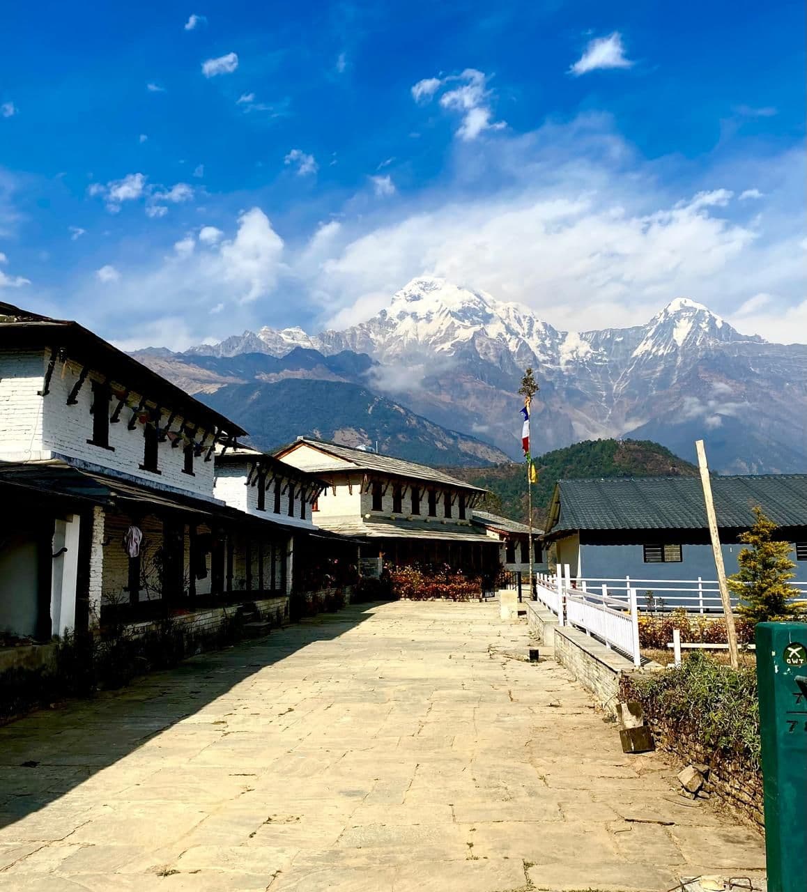 Teahouse lane in a village with Annapurna views