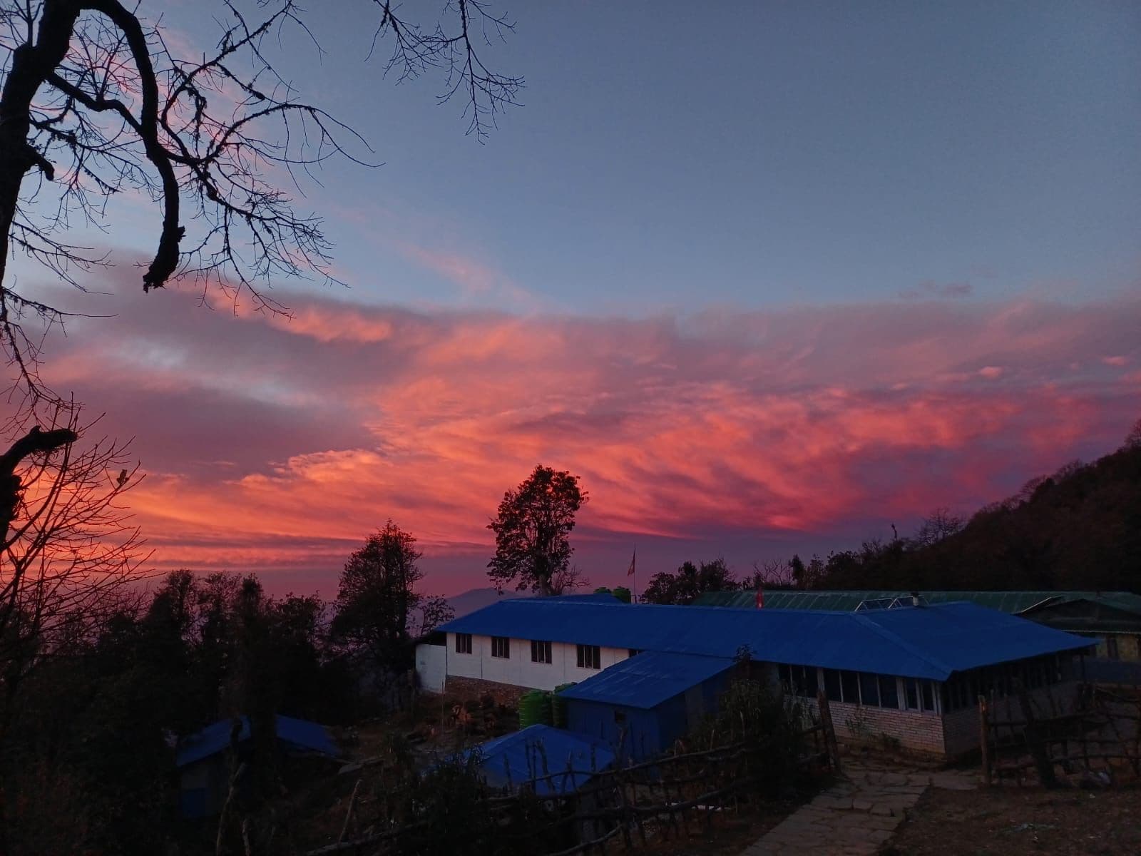 Red sunset over a hillside teahouse