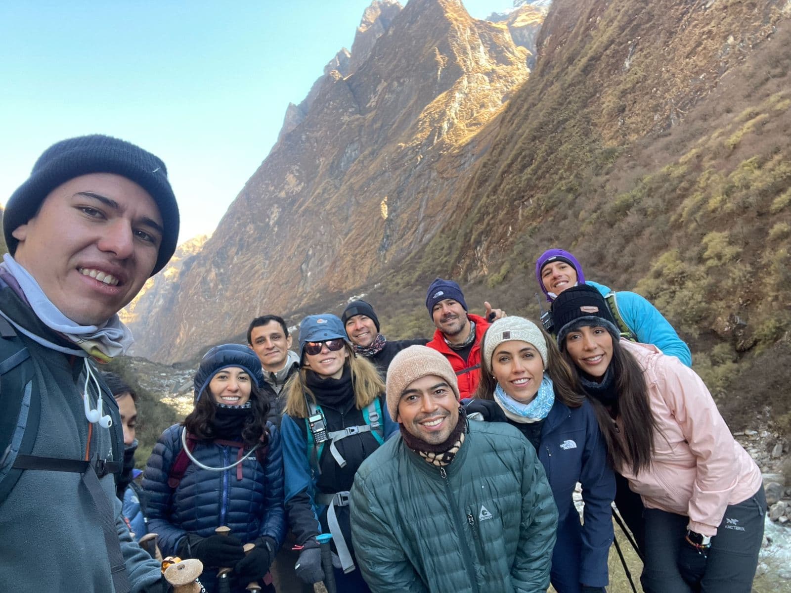 Group selfie of trekkers in a Himalayan valley