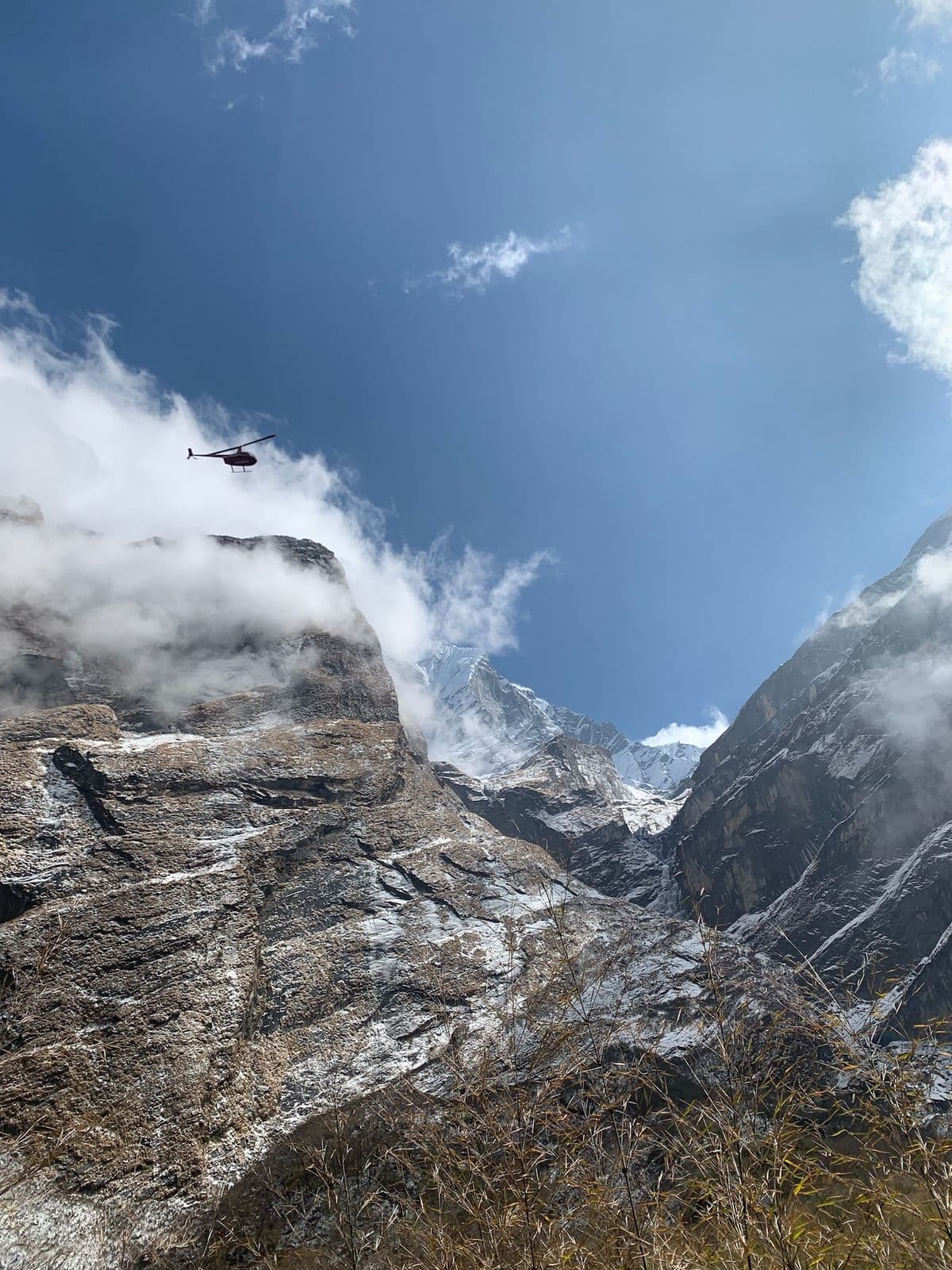 Clouds swirling around a rocky Himalayan face