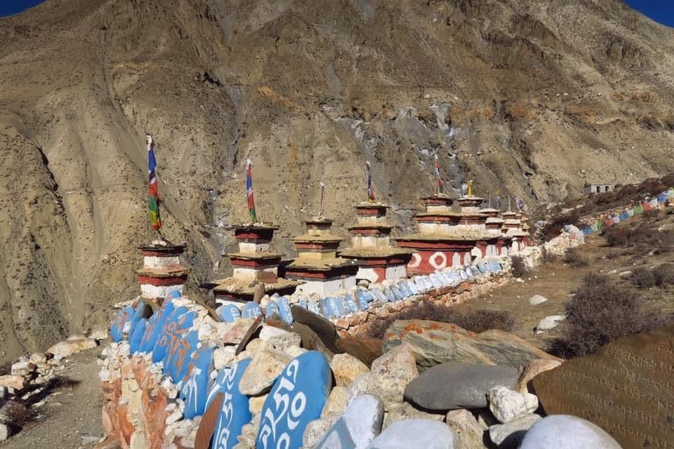 Painted mani stones and chortens in a dry valley