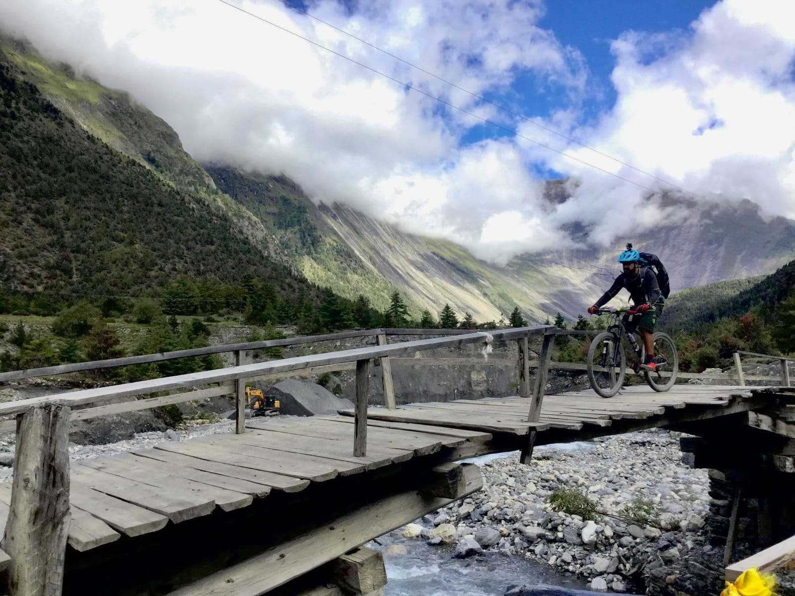 Mountain biker crossing a wooden bridge