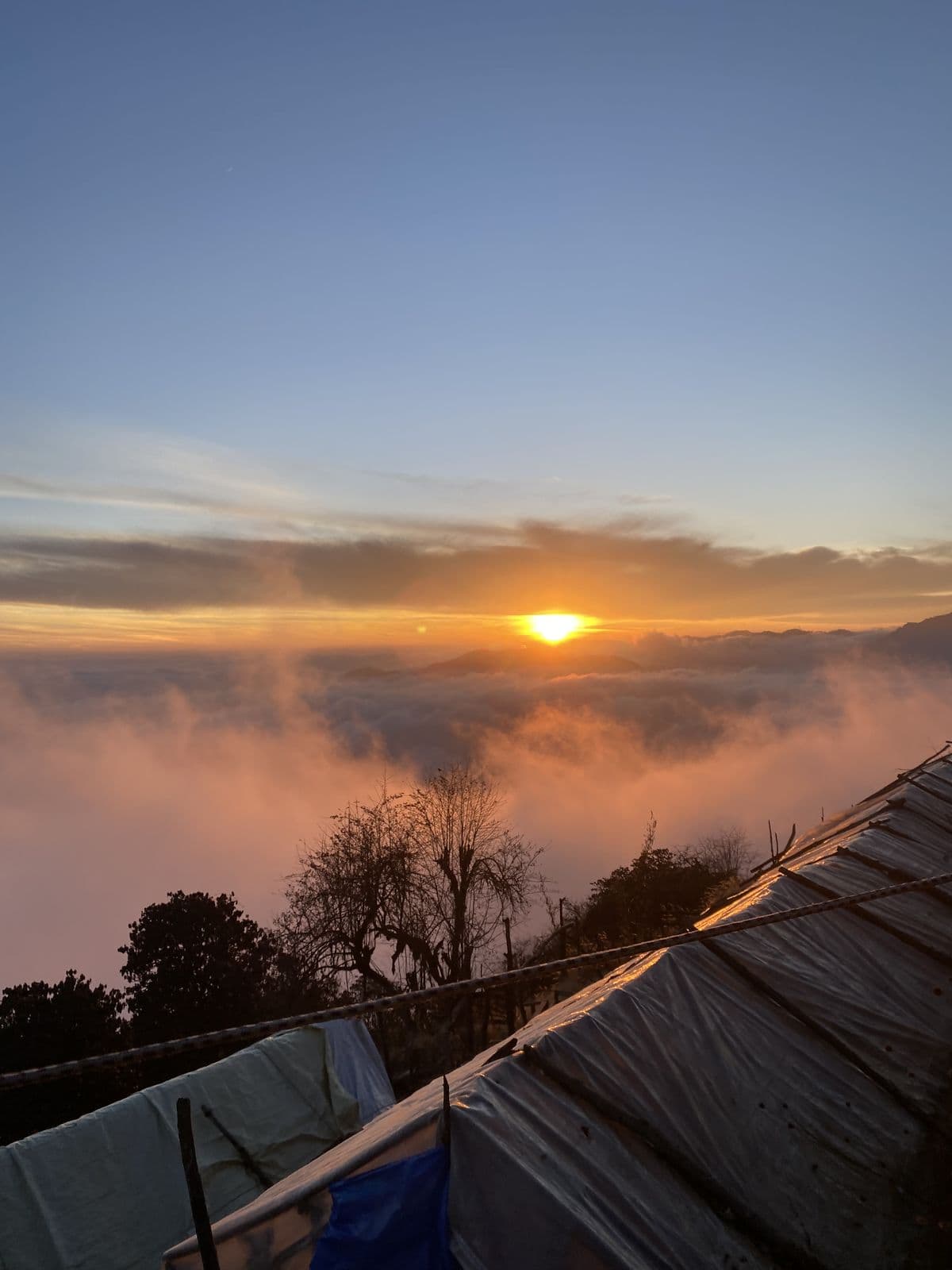 Sunrise above the clouds from a mountain lodge