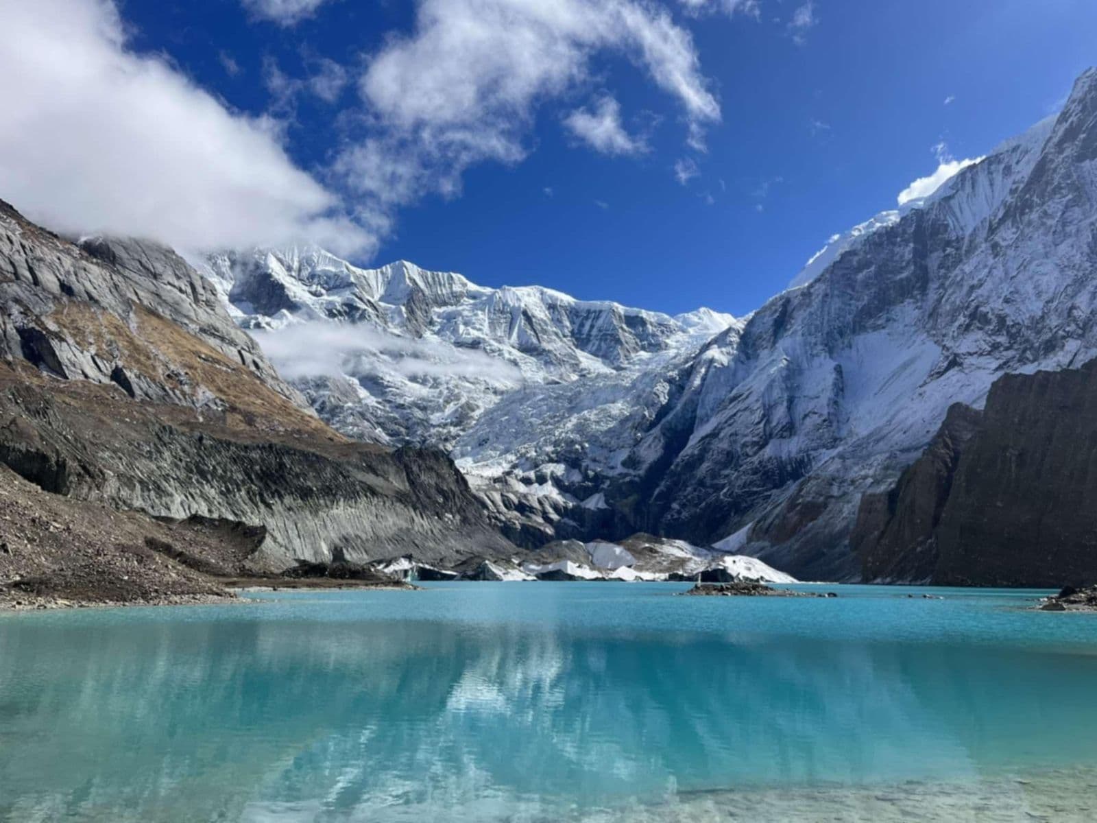 Turquoise glacial lake below hanging glaciers